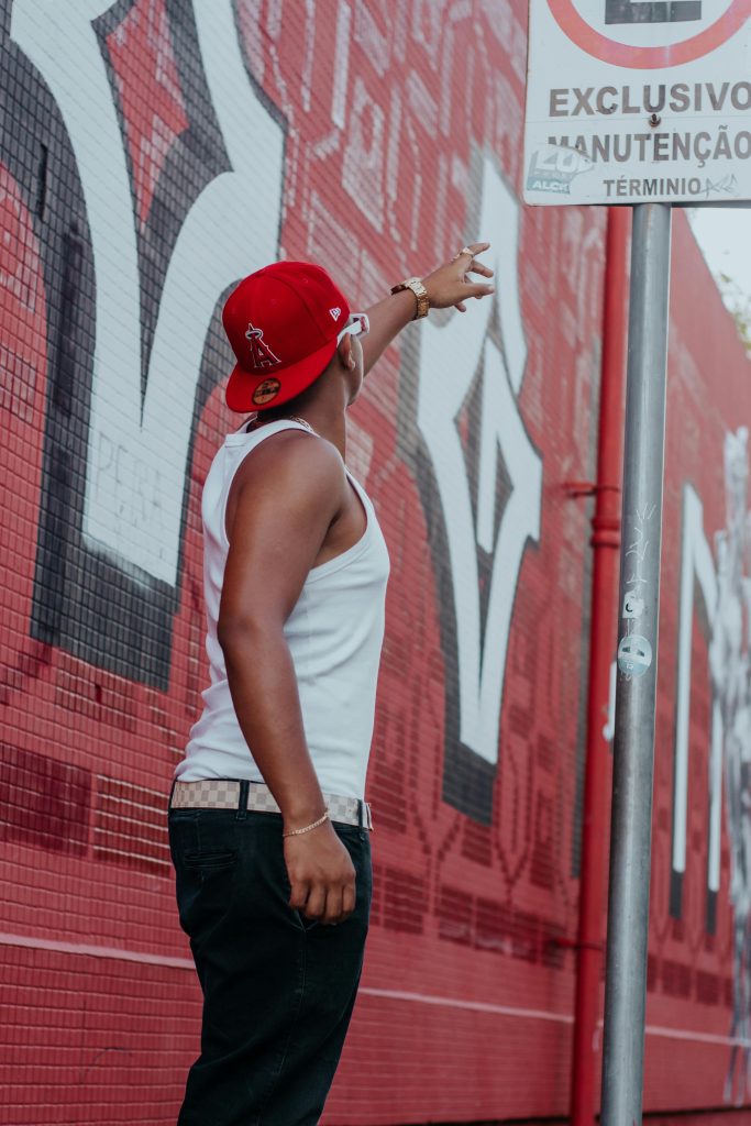 music artist pointing at a sign